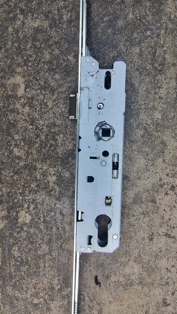 Faulty uPVC multipoint door locking mechanism removed for replacement during a door lock repair in Dulwich, London.